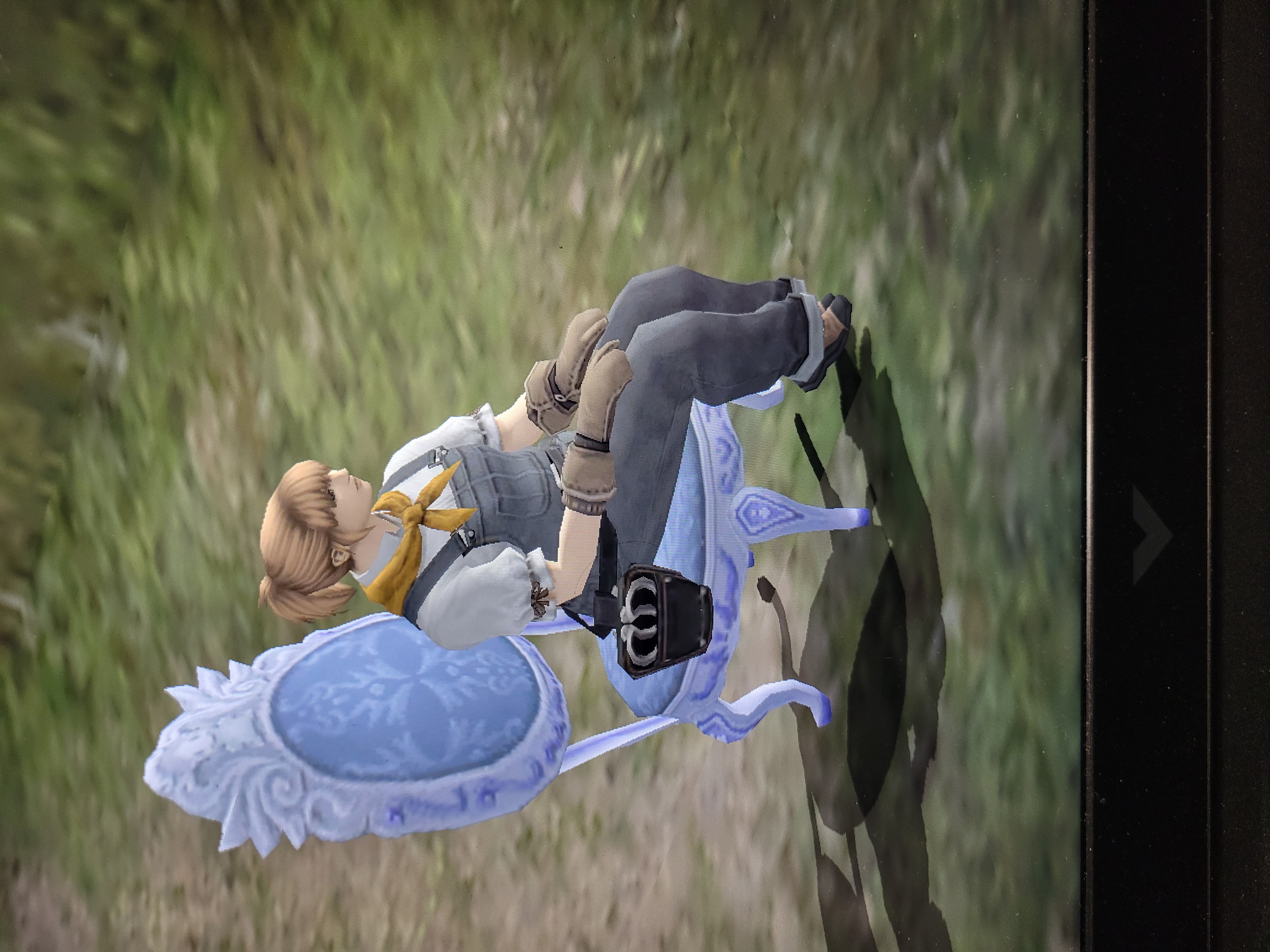Final Fantasy XI player character with white shirt and blue overalls sits on chair.